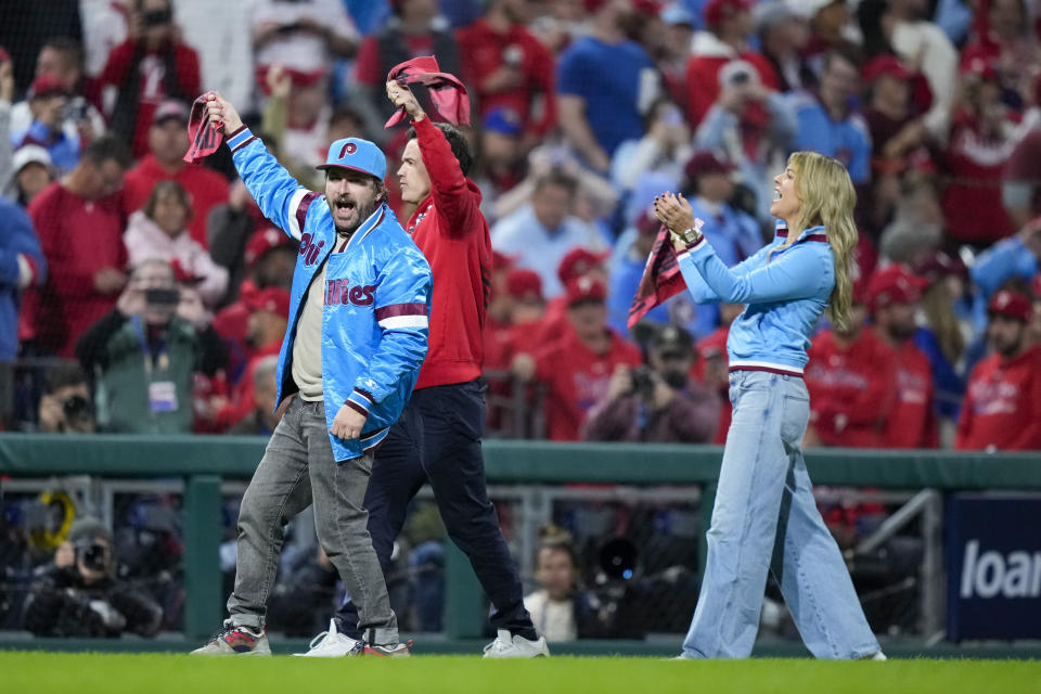 The cast of It's Always Sunny in Philadelphia cheer on the crowd during the fifth inning in Game 2 of the baseball NL Championship Series between the Philadelphia Phillies and the Arizona Diamondbacks in Philadelphia, Tuesday, Oct. 17, 2023. (AP Photo/Matt Slocum)