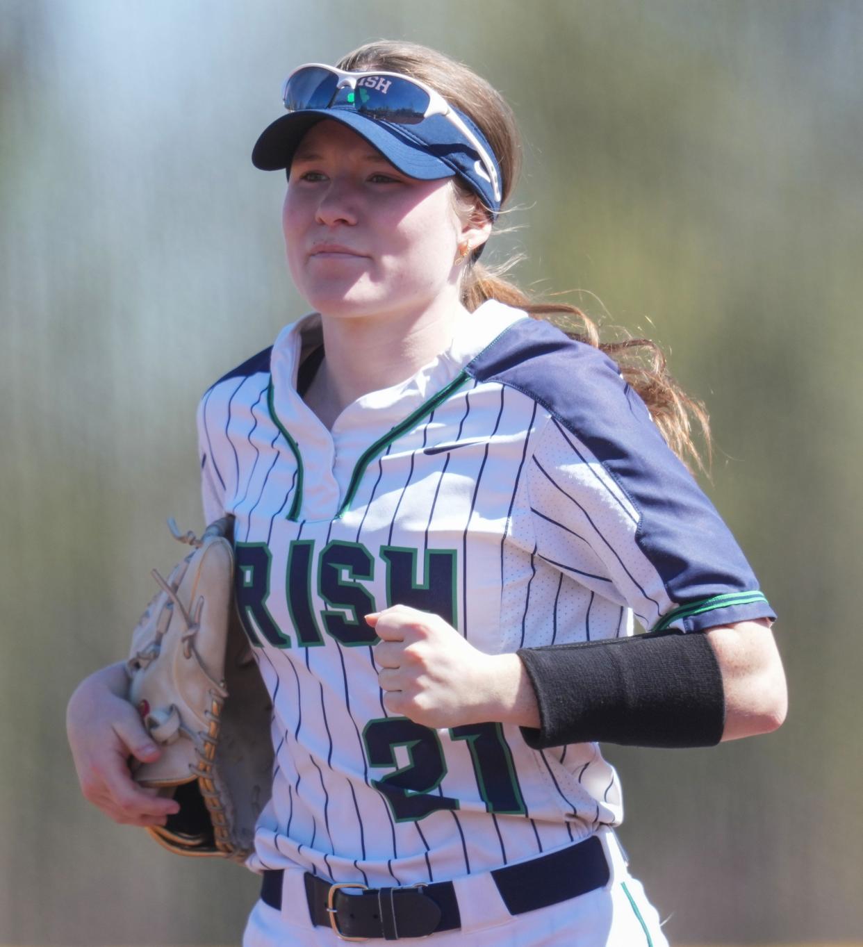 Cathedral Fighting Irish Mary Hughes (21) jogs back to the dugout Saturday, April 13, 2024, during the game at the Cathedral High School in Indianapolis.