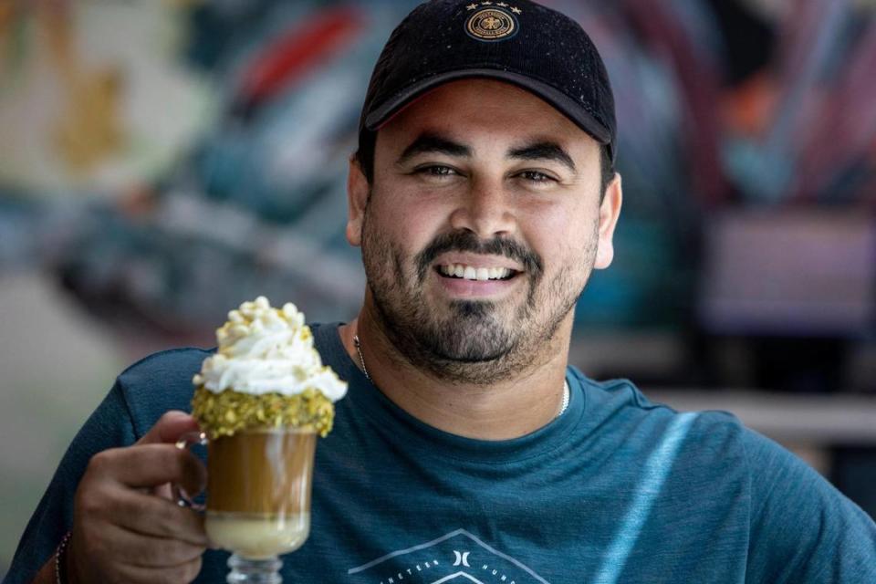 Coral Gables, FL- March 31 2023 - Jan Karlo Ruiz Ortiz, owner of the Bistro Café with a Pistacho Latte at the Bistro Café in Coral Gables. Bistro Cafe, 4155 Laguna Street, Coral Gables. Jose A. Iglesias/jiglesias@elnuevoherald.com