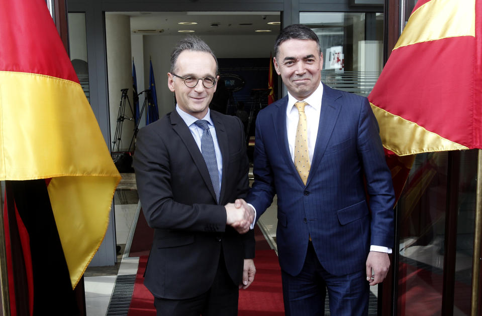 German Foreign Minister Heiko Maas, left, shakes hands with his North Macedonia's counterpart Nikola Dimitrov, right, upon his arrival at the foreign ministry in Skopje, North Macedonia, on Wednesday, Nov. 13, 2019. German Foreign Minister Maas arrived Wednesday in Skopje to discuss bilateral relations after North Macedonia failed to open European Union membership talks last month. (AP Photo/Boris Grdanoski)