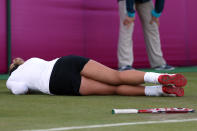 LONDON, ENGLAND - JULY 29: Sabine Lisicki of Germany slips on the grass and falls to the floor during the Women's Singles Tennis match against Ons Jabeur of Tunisia on Day 2 of the London 2012 Olympic Games at the All England Lawn Tennis and Croquet Club in Wimbledon on July 29, 2012 in London, England. (Photo by Clive Brunskill/Getty Images)