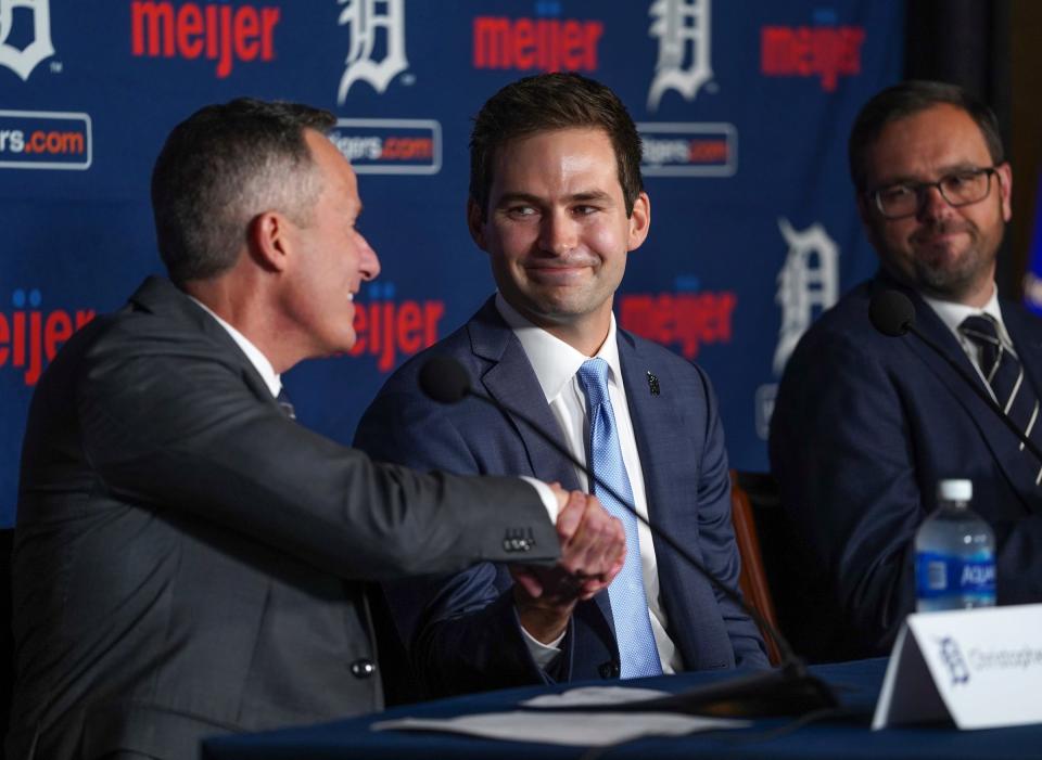 Tigers owner Christopher Ilitch shakes the hand of Scott Harris during a news conference about Harris' new role as the Tigers' president of baseball operations at Comerica Park in downtown Detroit on Tuesday, Sept. 20, 2022.