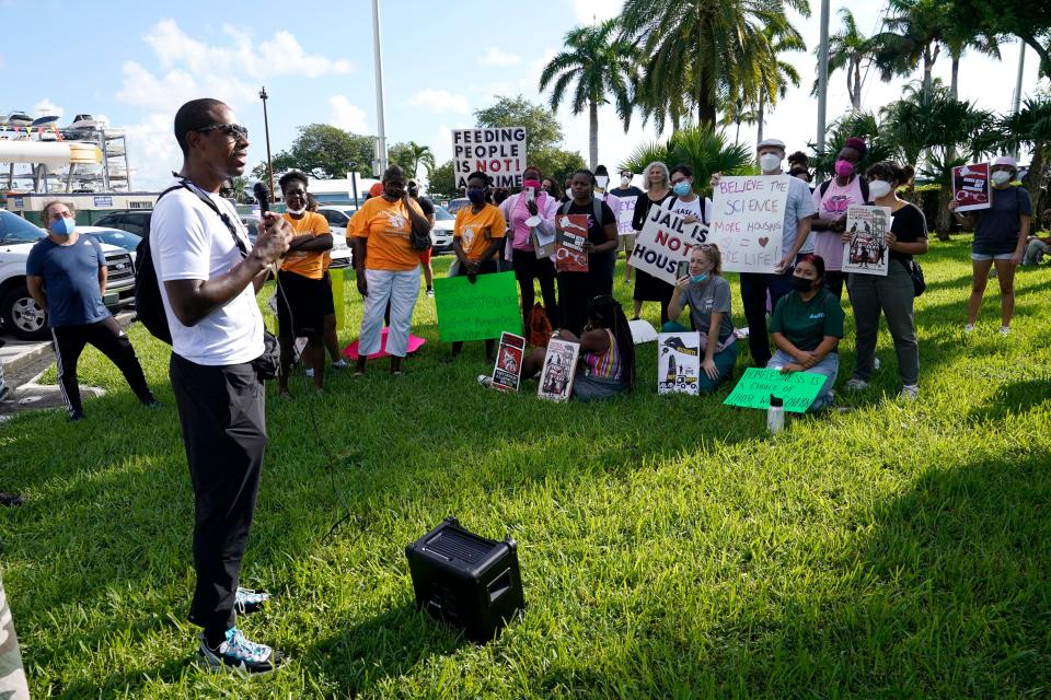 Dr. Armen Henderson, an advocate for social justice and homeless rights, speaks to a coalition of groups supporting homeless rights outside of City Hall on Oct. 14, 2021, in Miami. The Miami City Commission is proposing an ordinance that would allow private residents to "adopt" people experiencing homelessness in exchange for providing a stipend for utilities much like state-run foster care programs.