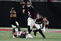 Atlanta Falcons quarterback Matt Ryan (2) eleudes the tackle of Tampa Bay Buccaneers punter Bradley Pinion (8) during the first half of an NFL football game, Sunday, Dec. 5, 2021, in Atlanta. (AP Photo/John Bazemore)