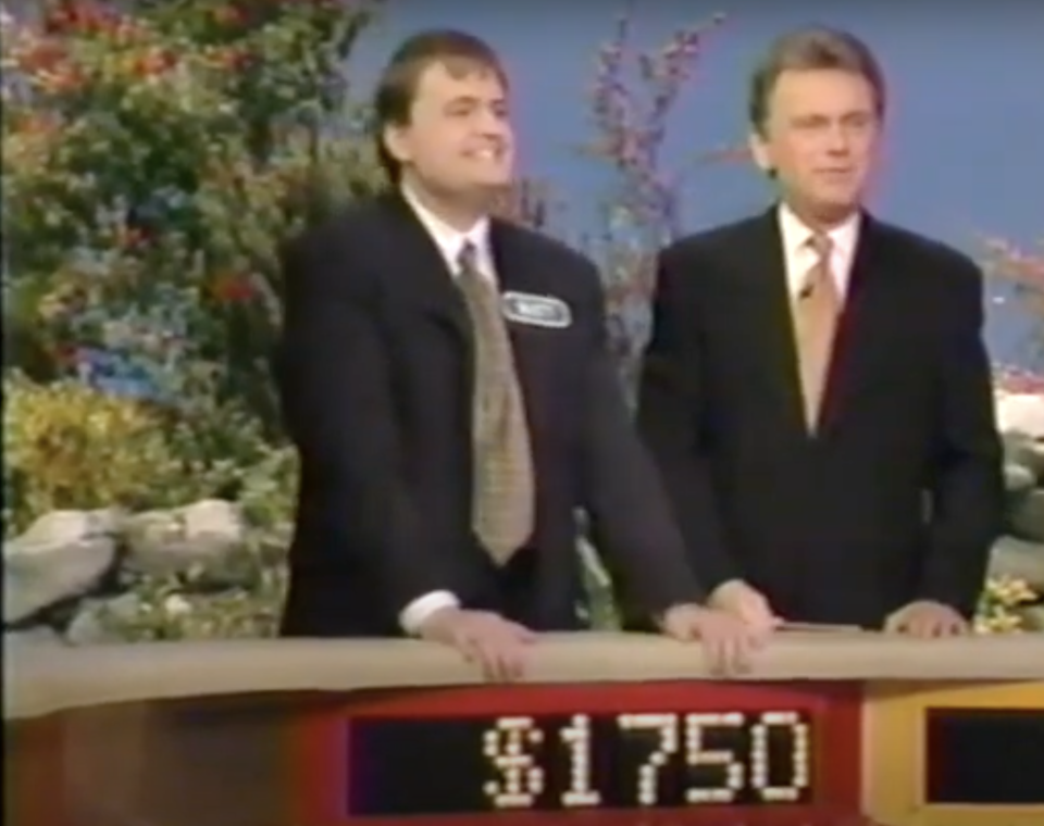 Matthew Fenwick appears on Wheel of Fortune next to host Pat Sajak in 1998. 