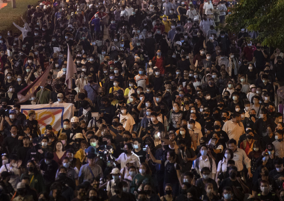 Hundreds of pro-democracy protesters demanding the release of pro-democracy activists march in Bangkok, Thailand, Wednesday, Feb. 10, 2021. Protesters demanded the government to step down, the constitution to be amended to make it more democratic and the monarchy be more accountable. (AP Photo/Sakchai Lalit)