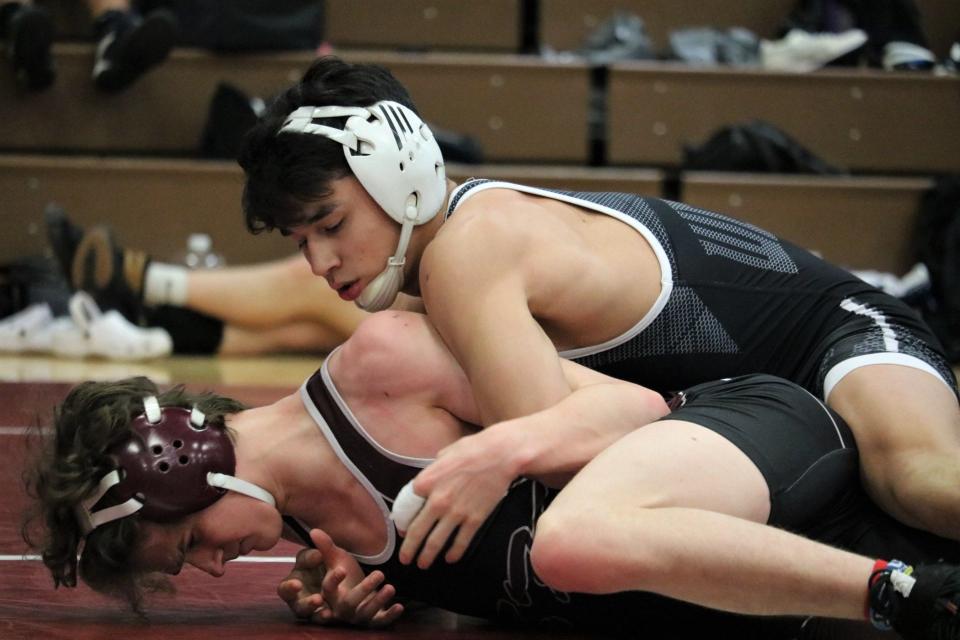 South Kitsap's Mitchell Neiner (top) competes during the South Kitsap wrestling invitational Saturday in Port Orchard.