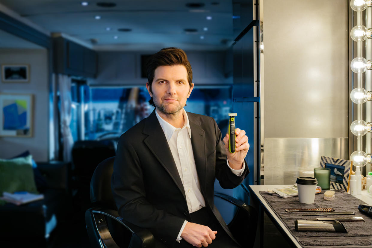 Adam Scott on set with Philips, holding Philips OneBlade 360