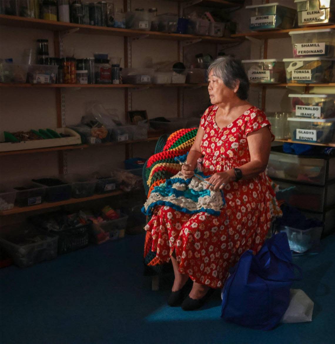 Angela Phang, 71, a client of Miami Lighthouse for the Blind who was born with congenital cataracts and retina problems, and is legally blind, crochets a scarf on Tuesday, Oct. 1, 2022. Phang has been a student of the Lighthouse’s Senior Group Activities (SGA) program since the 1980s and crochets scarfs to donate to charities.