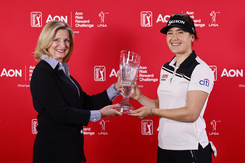 Pictured right, Australia's Hannah Green claims her trophy for winning the LPGA Tour's season-long bonus.