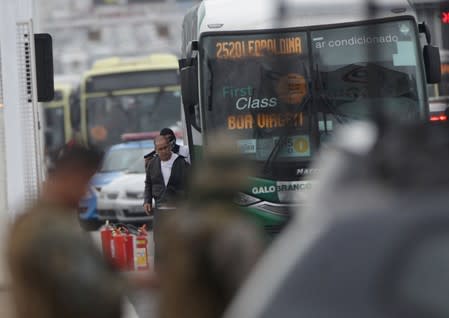 A man who hijacked a bus points a gun to a hostage's head on the Rio-Niteroi Bridge in Rio de Janeiro