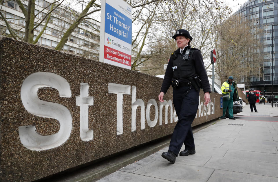 A police officer patrols outside a hospital where it is believed but not confirmed that Britain's Prime Minister Boris Johnson is undergoing tests after suffering from coronavirus symptoms, in London, Monday, April 6, 2020. British Prime Minister Boris Johnson has been admitted to a hospital with the coronavirus. Johnson's office says he is being admitted for tests because he still has symptoms 10 days after testing positive for the virus. (AP Photo/Frank Augstein)