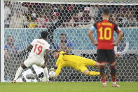 Belgium goalkeeper Thibaut Courtois makes a save on a penalty kick from Canada forward Alphonso Davies during the World Cup group F soccer match between Belgium and Canada, at the Ahmad Bin Ali Stadium in Doha, Qatar, Wednesday, Nov. 23, 2022. (Nathan Denette/The Canadian Press via AP)