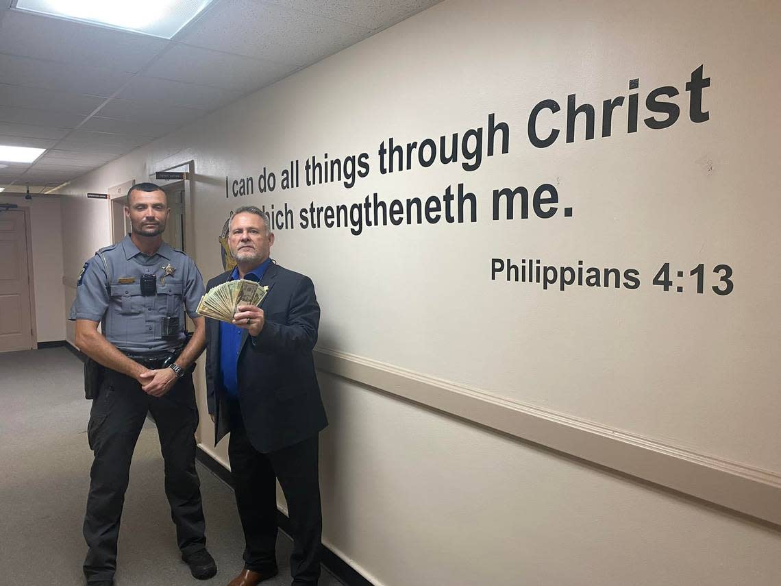 Former Columbus County Sheriff Jody Greene holds cash reflecting a donation from his deputies to a community member in need of medical care in September 2022.