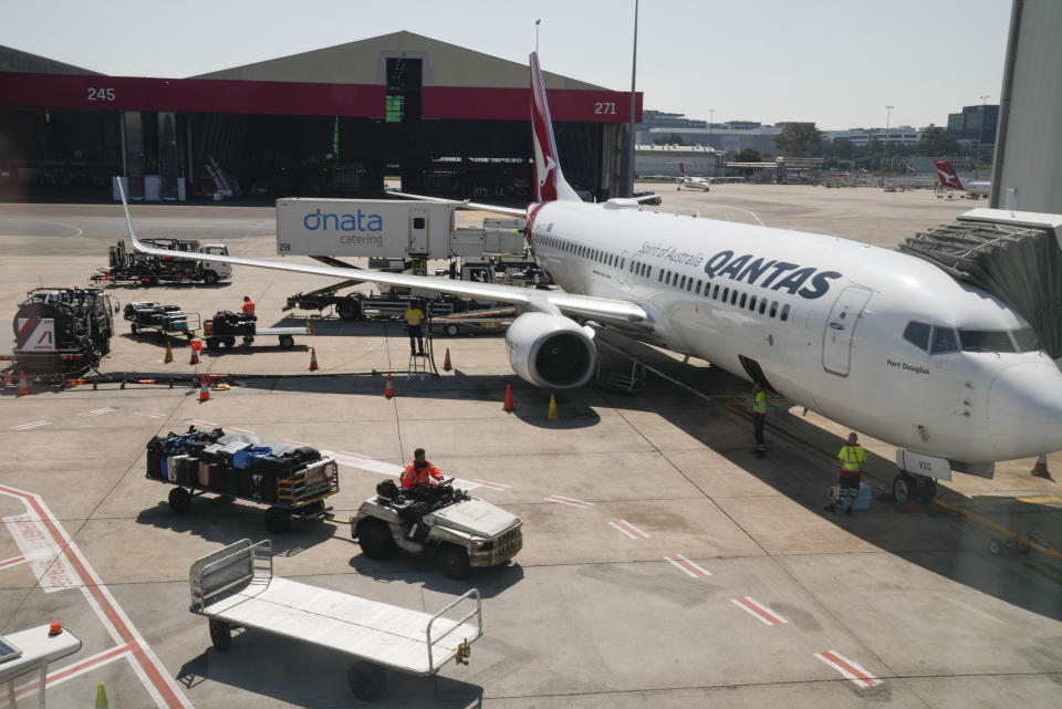 Baggage handlers work near a Qantas jet at Sydney's domestic terminal, Wednesday, Sept. 13, 2023. Qantas Airways lost its challenge to a court ruling on Wednesday that the Australian flag carrier had illegally fired 1,700 baggage handlers, cleaners and other ground staff at the height of pandemic travel disruptions. (AP Photo/Mark Baker)