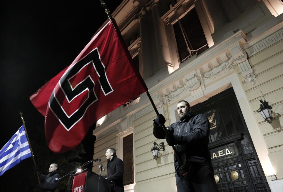 Ilias Kasidiaris lawmaker of Greece's extreme right party Golden Dawn delivers a speech during a rally in Athens on Saturday, Feb.1, 2014. About 3,000 people took part in the rally to commemorate a 1996 incident which cost the lives of three navy officers and brought Greece and Turkey to the brink of war. A number of leftist groups held two separate counter-rallies a short distance away, but police forbade the groups from marching and meeting each other to prevent violent incidents. Six lawmakers of the party, including the Golden Dawn's leader Nikolaos Michaloliakos, are in jail on charges of being prominent members of a criminal organization. (AP Photo/Yannis Kolesidis)