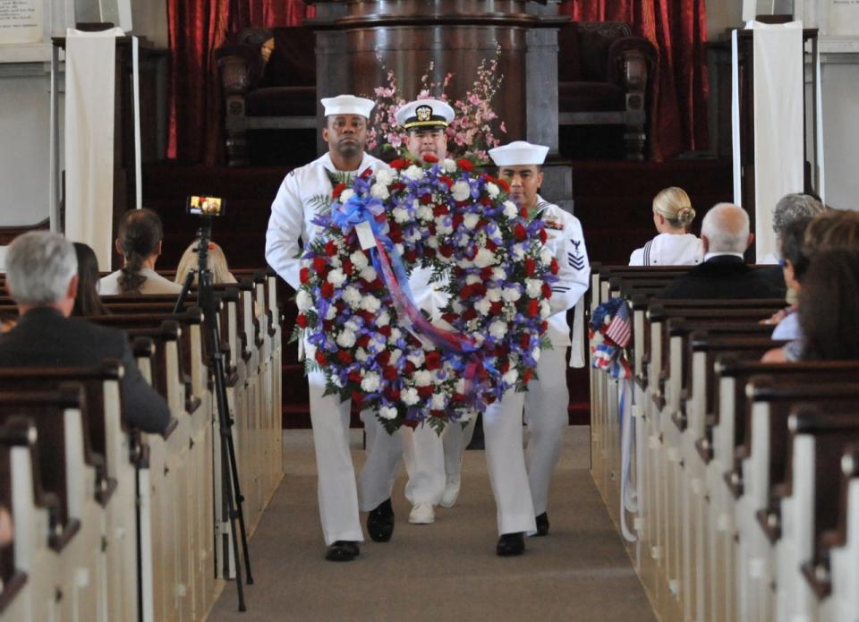 Quincy's Naval Operations Support Center honor guard members, from left, Kenneth Williams, Lt. Commander Ryan Seggerty, and Christopher Orlande carrying the presidential wreath to the crypt of President John Quincy Adams during a wreath laying ceremony at the United First Parish Church in Quincy on Thursday, July 11, 2019.