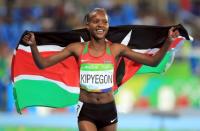 2016 Rio Olympics - Athletics - Final - Women's 1500m Final - Olympic Stadium - Rio de Janeiro, Brazil - 16/08/2016. Faith Chepngetich Kipyegon (KEN) of Kenya celebrates after winning the gold medal. REUTERS/Dominic Ebenbichler