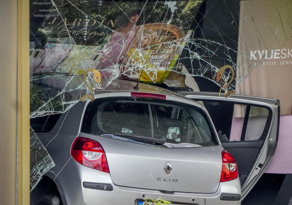 A car has crashed into a store after crashing into a crowd of people in central Berlin, Germany, Wednesday, June 8, 2022. (AP Photo/Michael Sohn)