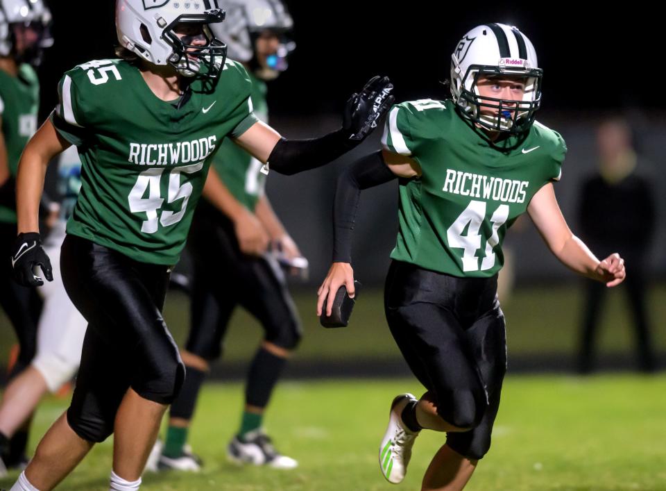 Richwoods' Jackson Lonteen (45) congratulates kicker Jasmine Bisping after her successful PAT against Peoria Notre Dame in the first half of their Week 4 football game Friday, Sept. 15, 2023 at Richwoods High School. The Irish routed the Knights 42-7.