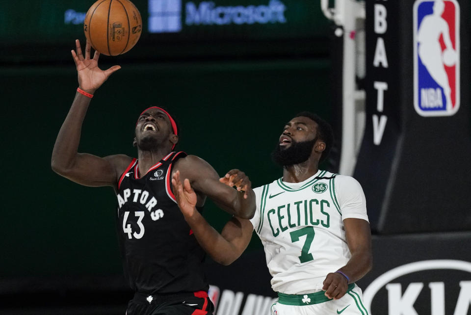 Toronto Raptors' Pascal Siakam (43) catches a pass in front of Boston Celtics' Jaylen Brown (7) during the second half of an NBA conference semifinal playoff basketball game Saturday, Sept. 5, 2020, in Lake Buena Vista, Fla. (AP Photo/Mark J. Terrill)