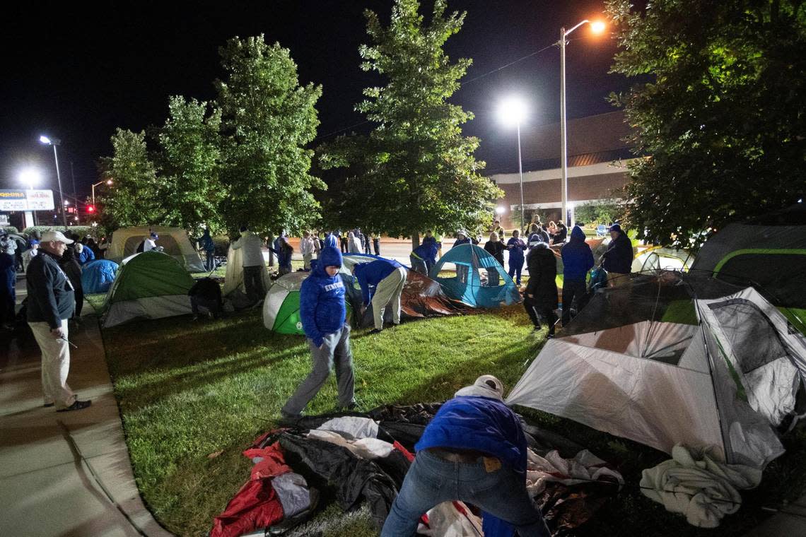 Fans rush to set up tents outside Memorial Coliseum for the Big Blue Madness campout in Lexington early Saturday morning.