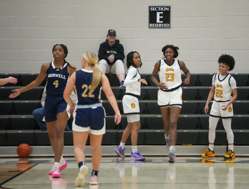 Fort Wayne Snider High School's Tia Phinezy (23) smiles after running into the bleachers on a hustle play against Norwell High School at Noblesville High School, Dec 28, 2023. Ft. Wayne Snyder won 65-50.