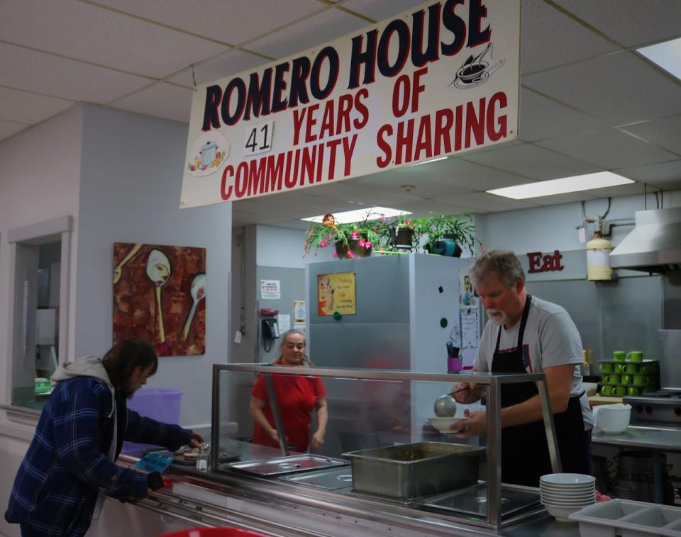 Volunteers Charlene Good and Jim McQuoid serve up corn chowder, baked goods and snacks. 