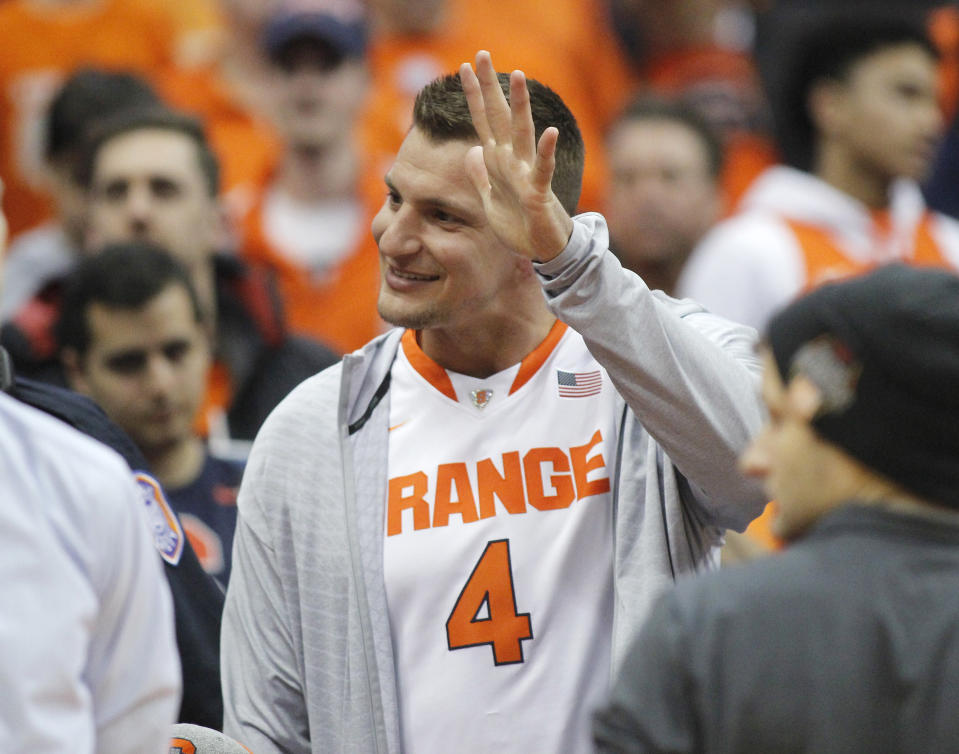 New England Patriots football player Rob Gronkowski waves to fans before Syracuse's NCAA college basketball game against Duke in Syracuse, N.Y., Saturday, Feb. 23, 2019. (AP Photo/Nick Lisi)