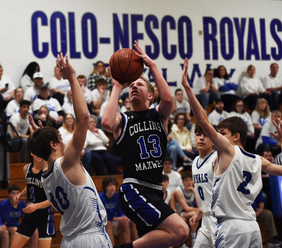 Collins-Maxwell's Josef Dvorak splits Colo-NESCO's Spencer Clatt (10) and Drew Banks (2) as he goes up for a shot during the second half of the Spartans' 63-61 overtime win in the 1A District 10 quarterfinals Monday at Colo. Dvorak had 24 points for the Spartans.
