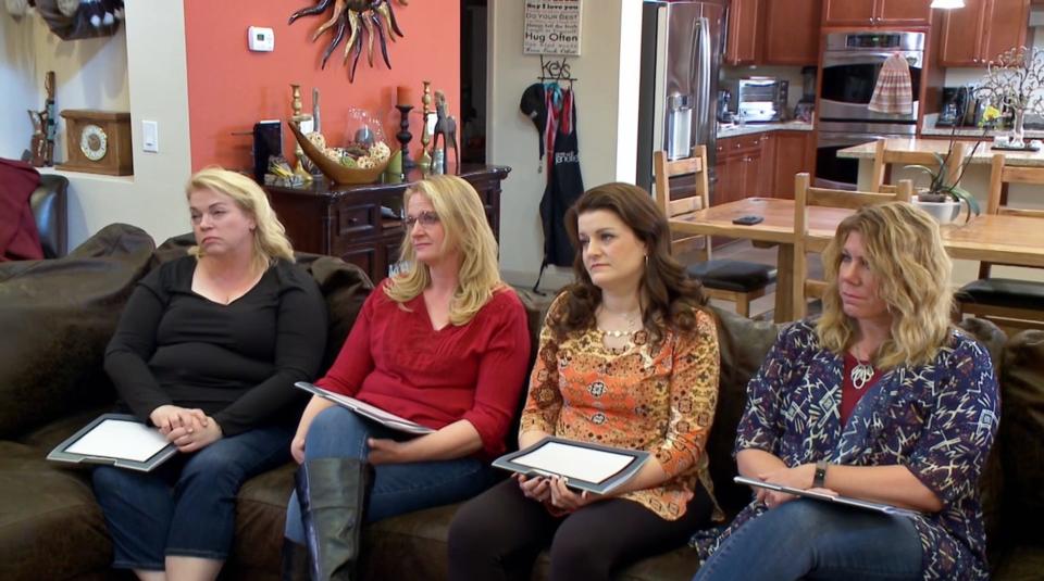 The Brown family wives on a couch.