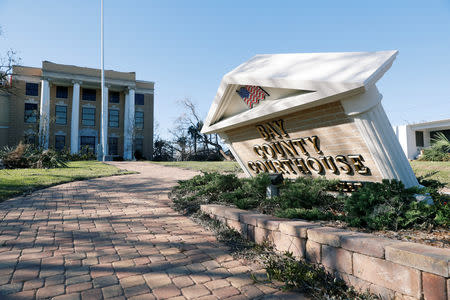 A sign stands askew in the aftermath of Hurricane Michael at the Bay County Courthouse in Panama City, Florida, U.S., October 13, 2018. REUTERS/Terray Sylvester