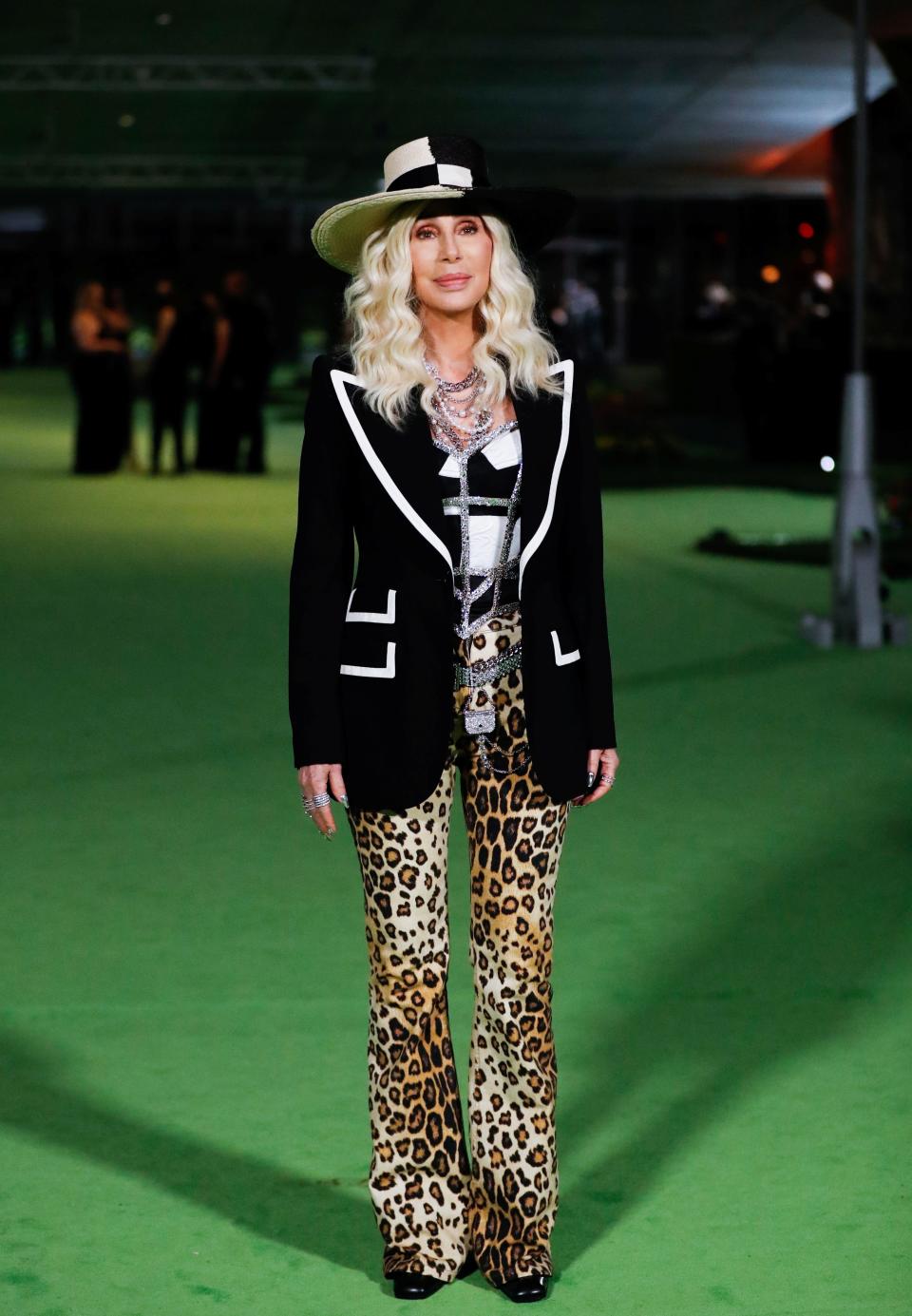 Cher posing for photos at the Academy Museum of Motion Pictures gala in Los Angeles, California, in 2021