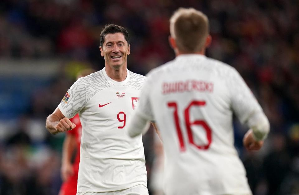 Poland’s Robert Lewandowski (left) celebrates with goalscorer Karol Swiderski after setting up Poland’s winner against Wales in Cardiff (Nick Potts/PA) (PA Wire)