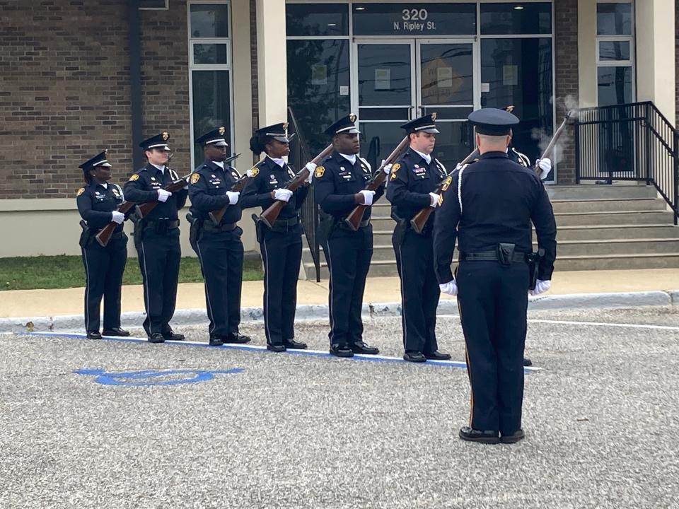 Montgomery police officers fire shots in honor of fallen peers.