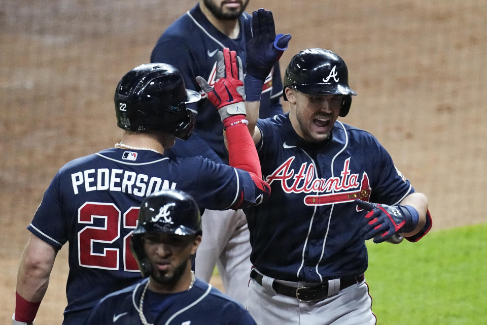 Atlanta Braves' Adam Duvall celebrates his two-run home run with Joc Pederson during the third inning of Game 1 in baseball's World Series between the Houston Astros and the Atlanta Braves Tuesday, Oct. 26, 2021, in Houston. (AP Photo/Eric Gay)