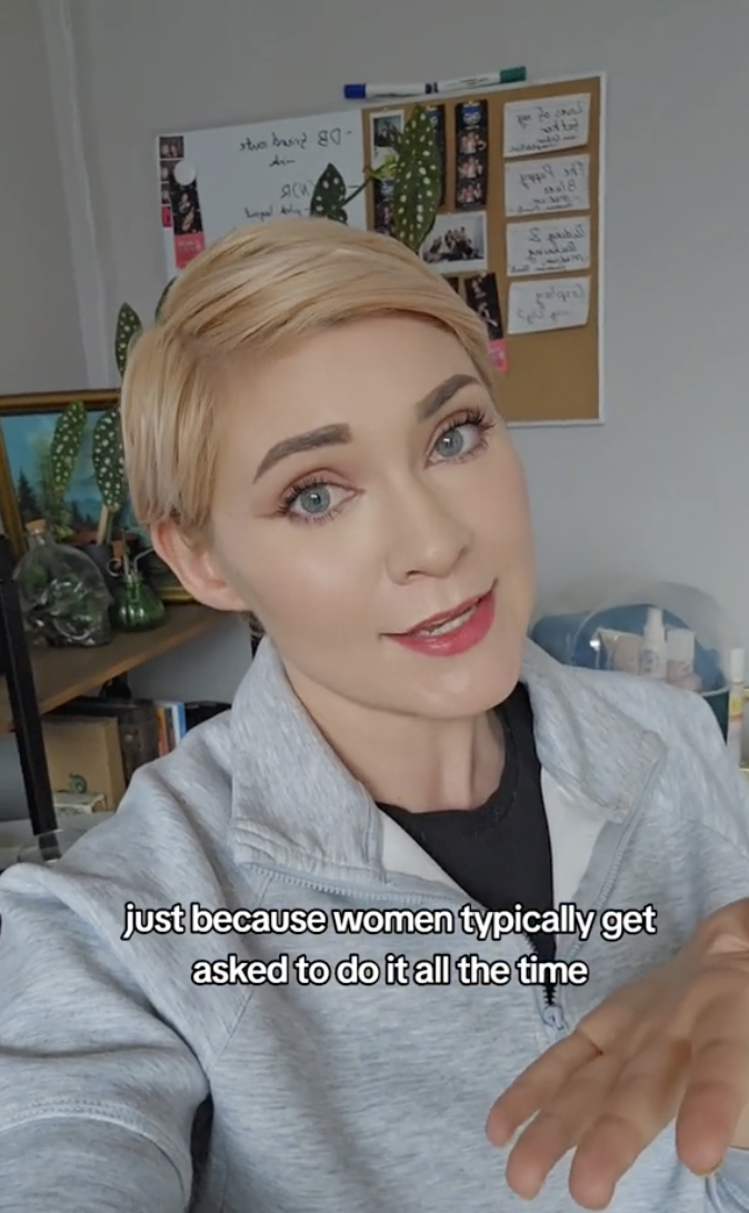 Person in a hooded sweater speaking, subtitled text about women frequently asked to multitask