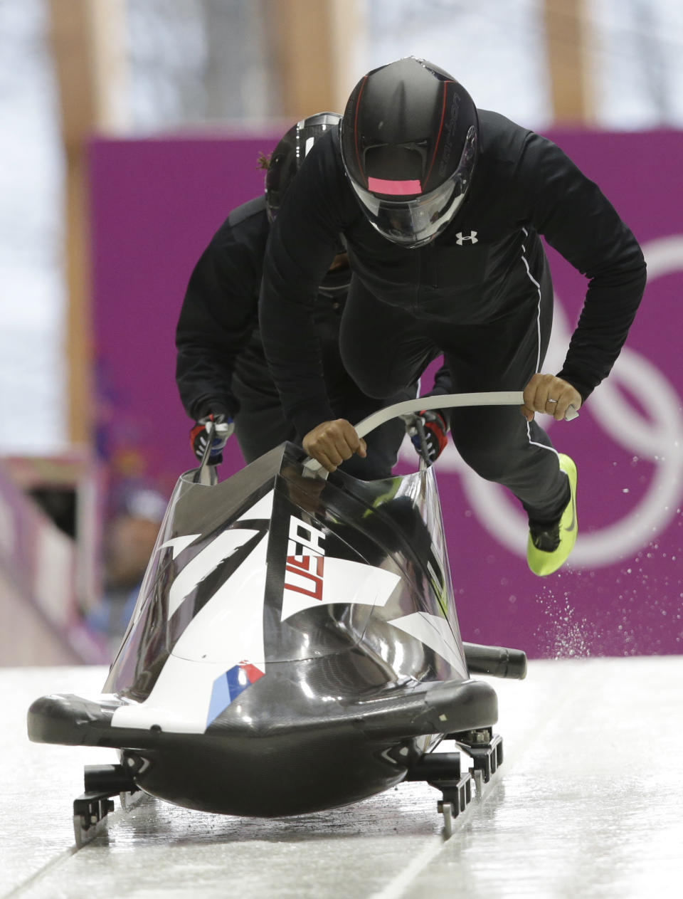 The team from the United States USA-1, piloted by Elana Meyers, start a run during a women's bobsleigh training session at the 2014 Winter Olympics, Saturday, Feb. 15, 2014, in Krasnaya Polyana, Russia. (AP Photo/Dita Alangkara)