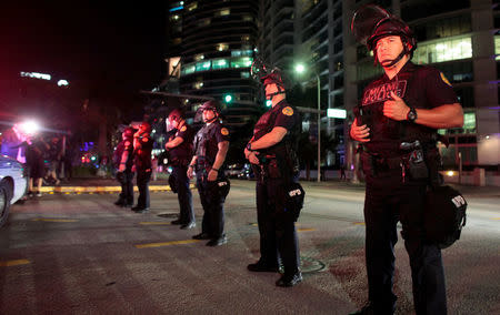 Police officers stand guard during a protest against U.S. President-elect Donald Trump in Miami, Florida, U.S. November 11, 2016. REUTERS/Javier Galeano