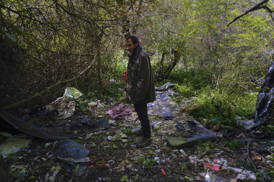 Juan Jimenez, 60, stands in the place where he lived for six months before using his car as a home, in Pamplona, northern Spain. Tuesday, March 17, 2021. Jimenez has been forced to dwell in his second-hand Ford for close to a year after seeing his life collapse when he and his wife bought a bigger house, only for mortgage payments to spiral out of control and for their marriage to crumble after the economic slowdown caused by the coronavirus pandemic destroyed his financial stability. (AP Photo/Alvaro Barrientos)