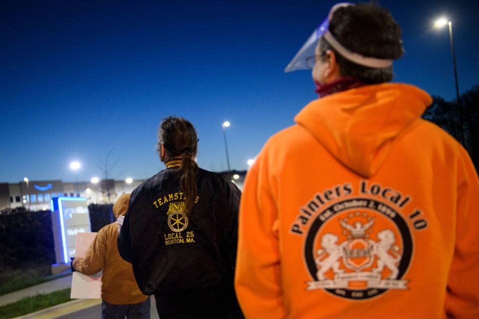 Union supporters distribute information before sunrise outside of the Amazon.com, Inc. BHM1 fulfillment center on March 29, 2021 in Bessemer, Alabama. - Votes are set to be counted on March 29, 2021 on whether to create the first Amazon union in the United States, at a warehouse in Alabama, after a historic, five months-long David vs Goliath campaign. 