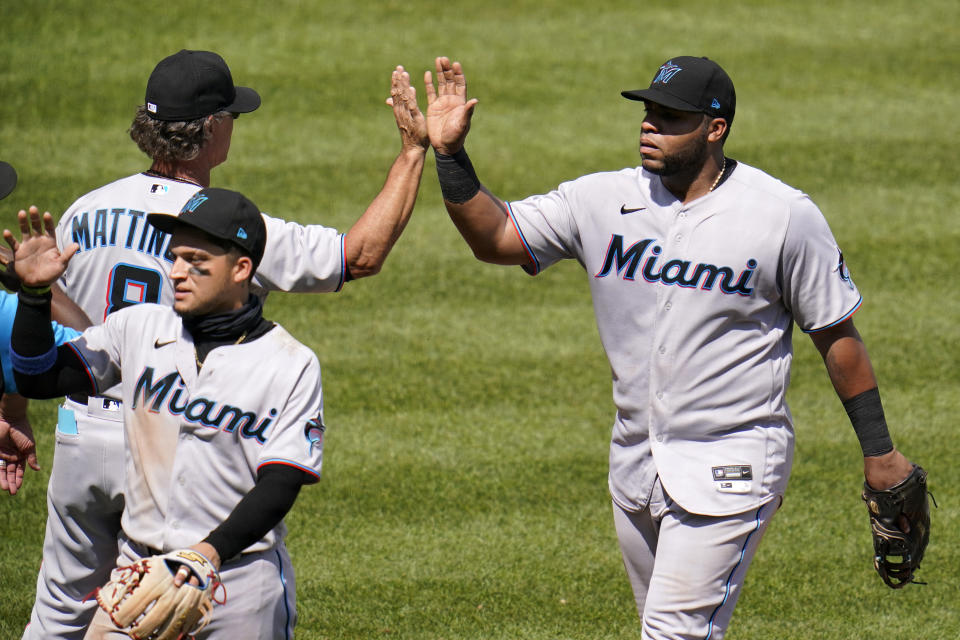 Miami Marlins first baseman Jesus Aguilar, right, is greeted by manager Don Mattingly as he walks off the field following a baseball game against the Pittsburgh Pirates in Pittsburgh, Sunday, June 6, 2021. The Marlins won 3-1. (AP Photo/Gene J. Puskar)