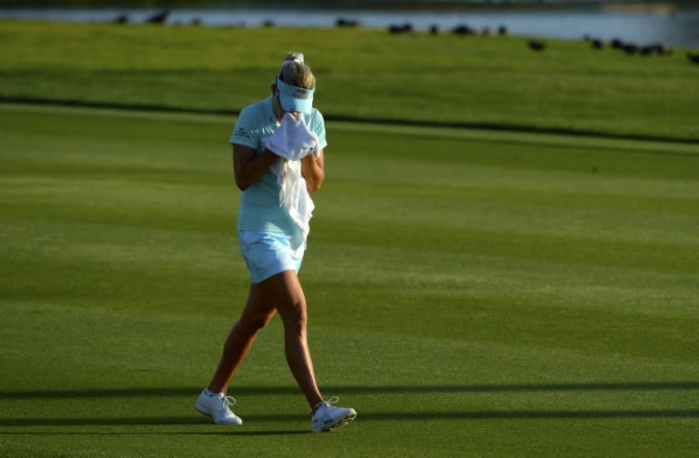 Lexi Thompson cries in a towel as she walks to the 18th green after her second shot during the final round of the ANA Inspiration on the Dinah Shore Tournament Course on April 2, 2017 in California