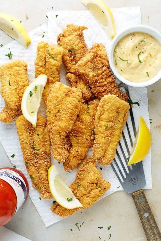 <p>Grandbaby Cakes</p><p>This classic southern Fried Catfish recipe is dredged in a perfectly seasoned and spiced cornmeal breading and fried until tender on the inside and crispy golden brown on the outside!</p><p><strong>Get the Recipe:</strong><strong><a href="https://grandbaby-cakes.com/fried-catfish/" rel="nofollow noopener" target="_blank" data-ylk="slk:Fried Catfish;elm:context_link;itc:0;sec:content-canvas" class="link rapid-noclick-resp"> Fried Catfish</a></strong></p>