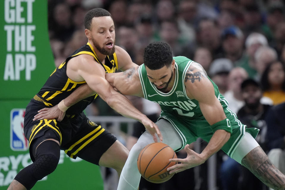 Golden State Warriors guard Stephen Curry, left, and Boston Celtics forward Jayson Tatum, right, vie for control of the ball in the first half of an NBA basketball game, Sunday, March 3, 2024, in Boston. (AP Photo/Steven Senne)