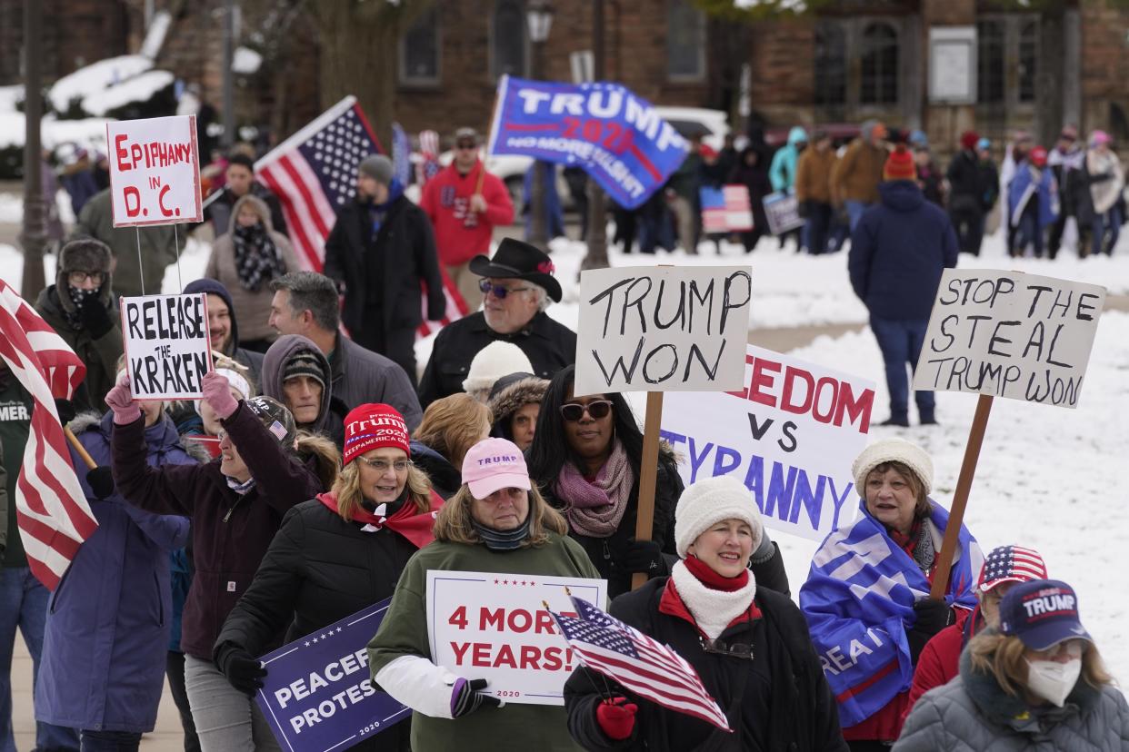 People attend a rally in support of President Donald Trump at the state capitol in Lansing, Mich., Wednesday, Jan. 6, 2021.