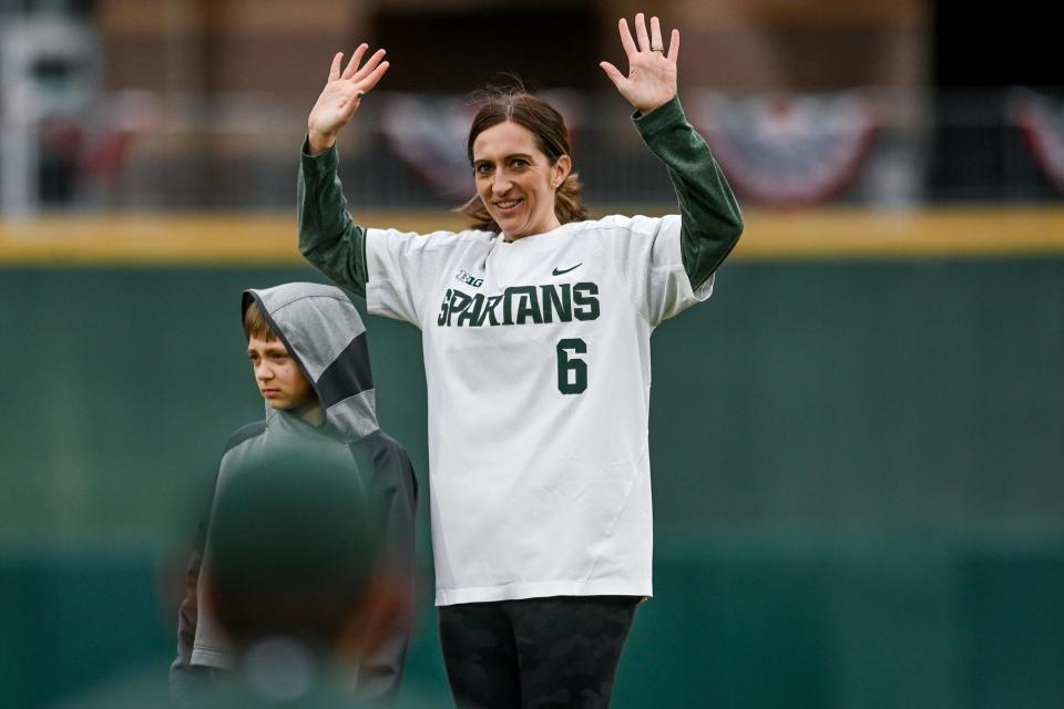 Michigan State's new women's basketball head coach Robyn Fralick waves to the crowd before her son William throws out the opening pitch on Tuesday, April 4, 2023, before the Crosstown Showdown at Jackson Field in Lansing.