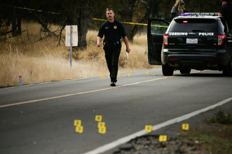 A law enforcement officer is seen at one of many crime scenes after the shooting