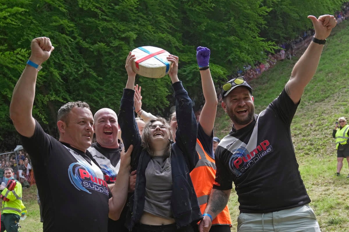 Delaney Irving holds her cheese aloft in victory (AP Photo/Kin Cheung)