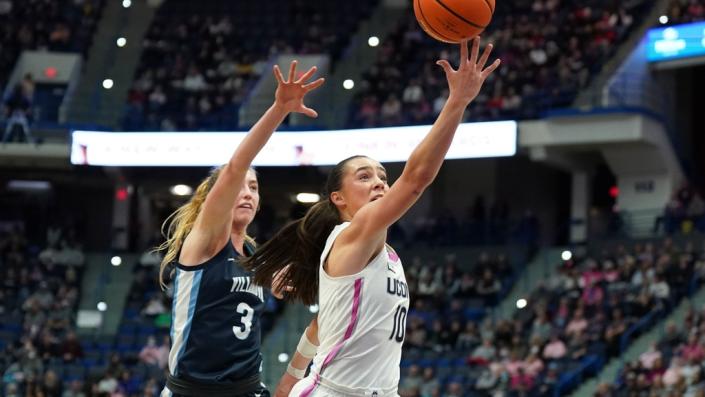 Jan 29, 2023; Hartford, Connecticut, USA; UConn Huskies guard Nika Muhl (10) drives to the basket against Villanova Wildcats guard Lucy Olsen (3) in the first half at XL Center.
